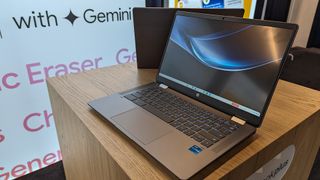 New Chromebook Plus, built by HP, pictured on a shelf with Google Gemini branding banners in the background.